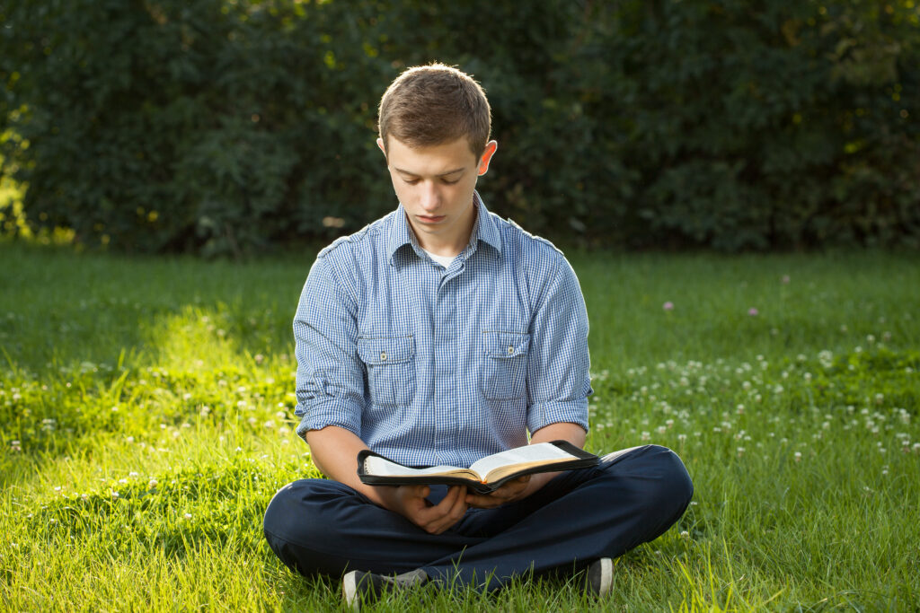 Young man reading Bible 1