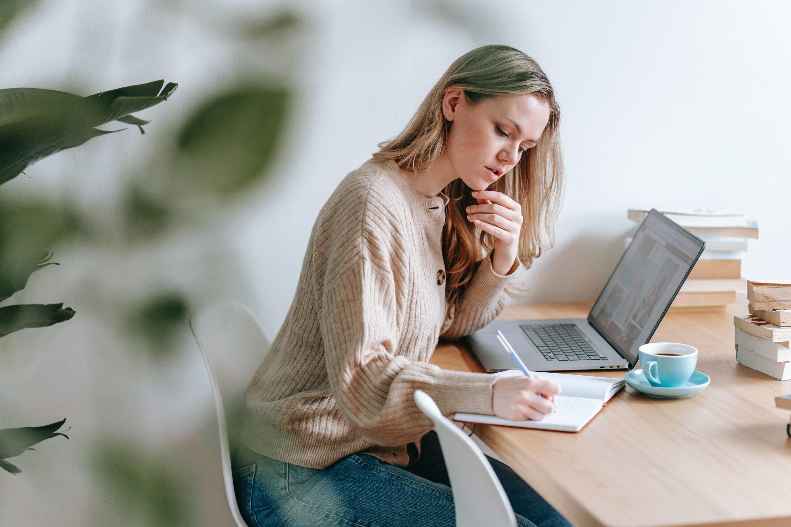 Woman taking notes at a computer