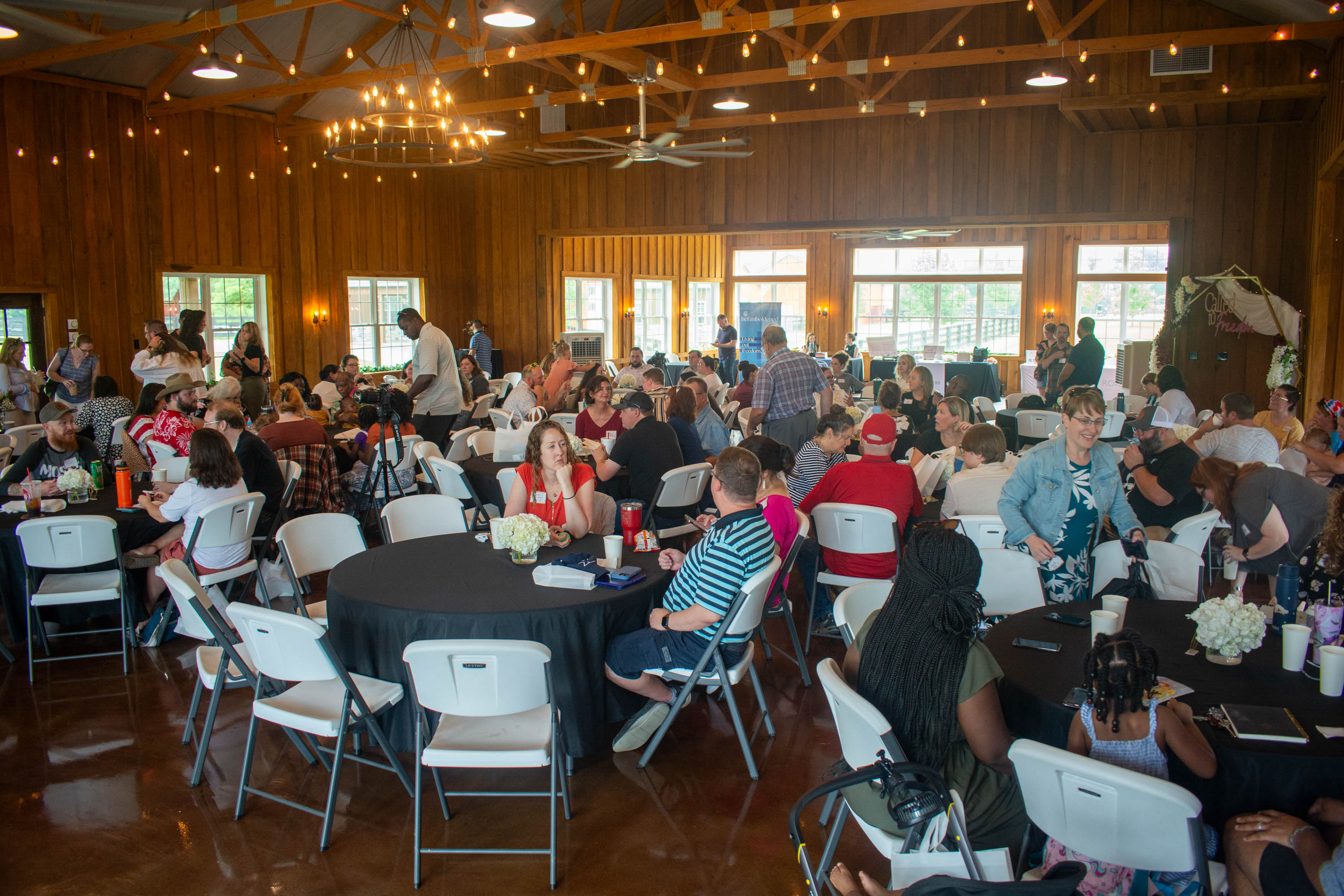 Conference attendees chatting at their tables
