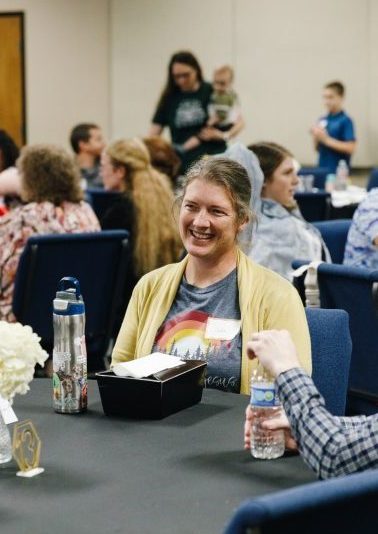 Conference attendees chatting at their tables